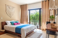 a bedroom with a bed and a balcony